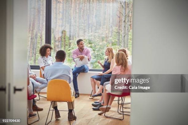 woman talking in group therapy session - encouragement stock pictures, royalty-free photos & images
