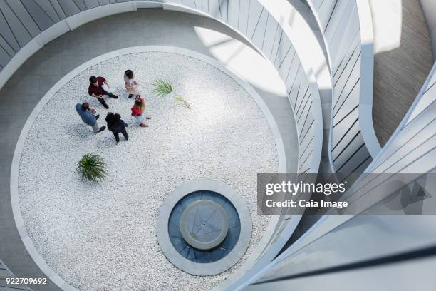 view from above business people talking in round modern office atrium courtyard - round five bildbanksfoton och bilder
