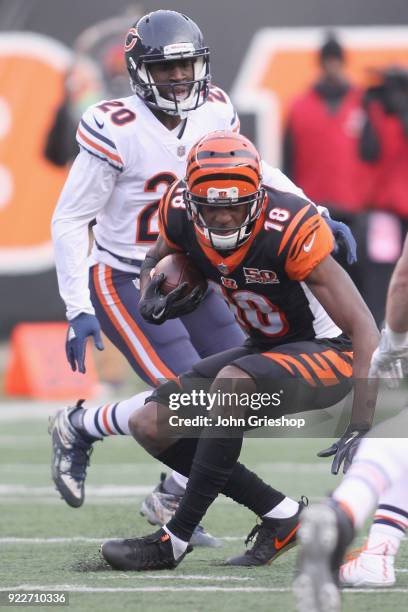 Green of the Cincinnati Bengals runs the football upfield against KeiVarae Russell of the Chicago Bears during their game at Paul Brown Stadium on...