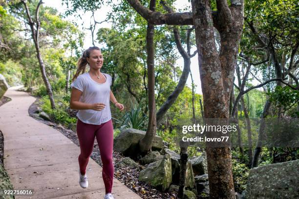 diabetes woman enjoying morning run along the coast - diabetic footwear stock pictures, royalty-free photos & images