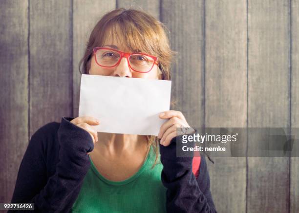 mature mid age woman holding blank board - placard stock pictures, royalty-free photos & images