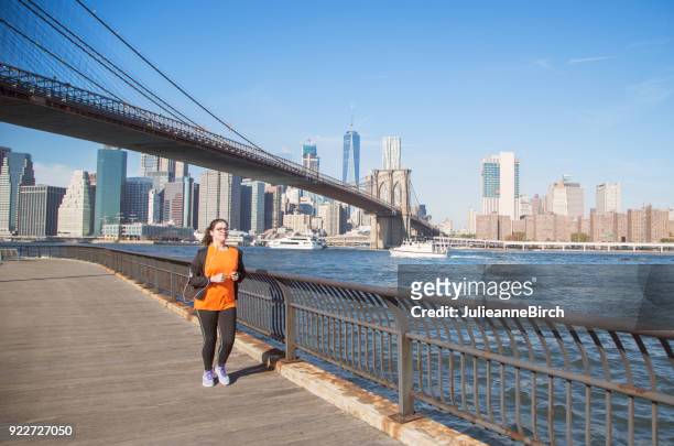 young teenager out jogging for exercise, along east river,  brooklyn heights promenade - brooklyn heights stock pictures, royalty-free photos & images