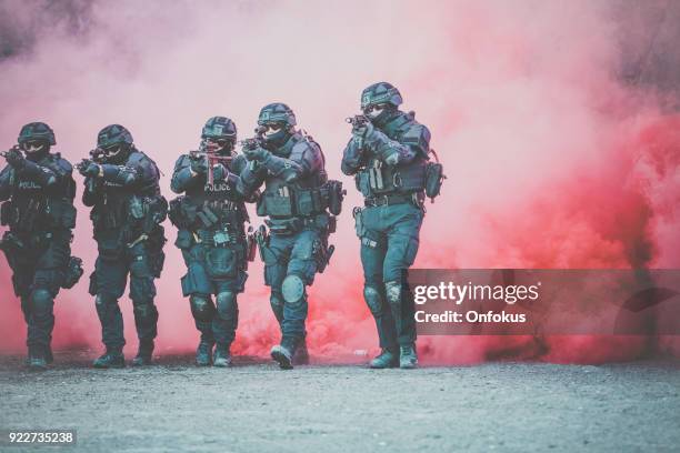 agenti di polizia swat sparano con arma da fuoco - task force foto e immagini stock