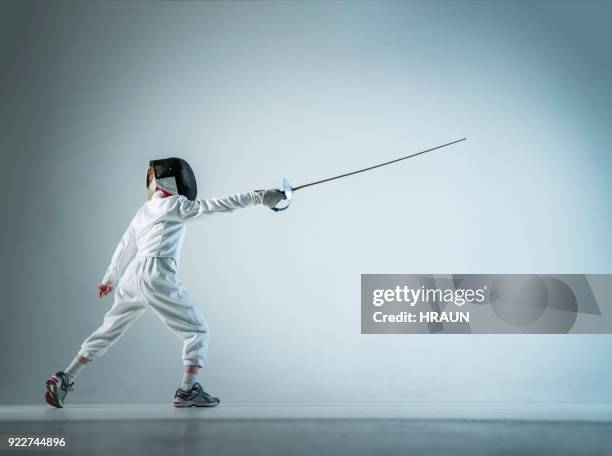 boy fencing lunge over white background - fencing sport stock pictures, royalty-free photos & images