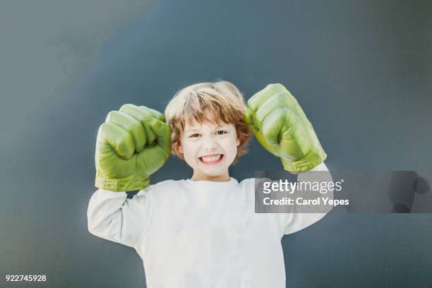 boy playing in fake fists