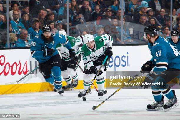 Tyler Pitlick of the Dallas Stars skates with the puck against Brent Burns of the San Jose Sharks at SAP Center on February 18, 2018 in San Jose,...