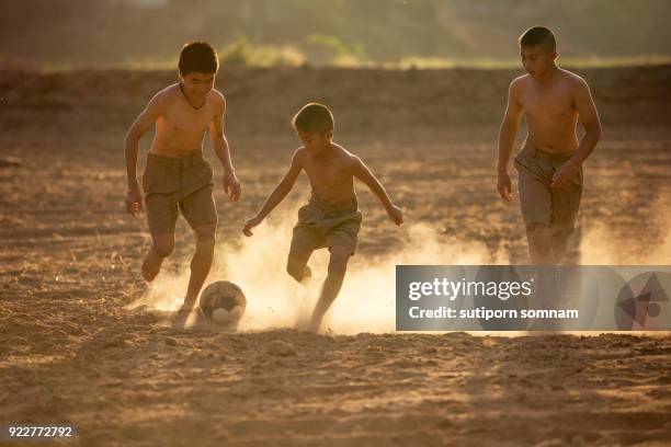 children playing the football - boy thailand stock-fotos und bilder