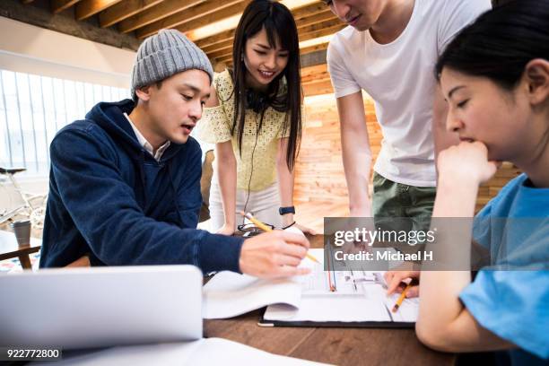 startup colleagues discussing in meeting - new business asian stock pictures, royalty-free photos & images