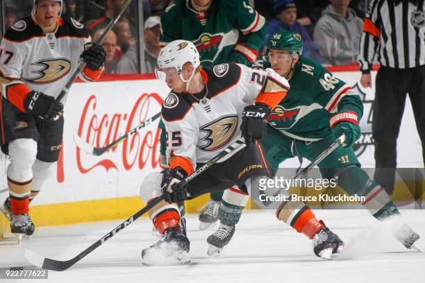 Ondrej Kase of the Anaheim Ducks skates with the puck while Jared Spurgeon of the Minnesota Wild defends during the game at the Xcel Energy Center on...