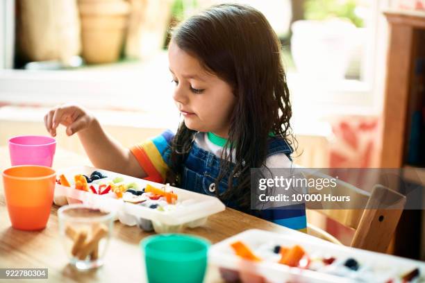 girl eating snacks - ice cube tray stock pictures, royalty-free photos & images