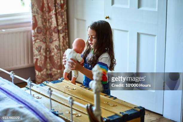 girl playing in bedroom - doll stock pictures, royalty-free photos & images