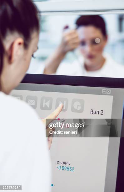 scientist using computer monitor - computer scientist stock pictures, royalty-free photos & images