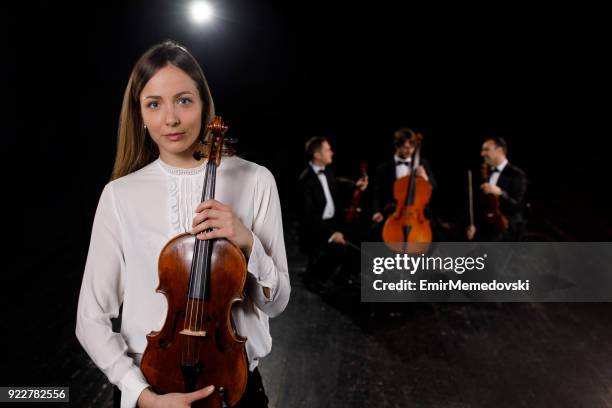 portrait of a female musician holding violin - beautiful woman violinist stock pictures, royalty-free photos & images
