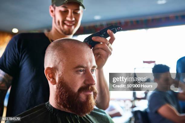 man getting haircut in barbershop - shaved head stock pictures, royalty-free photos & images