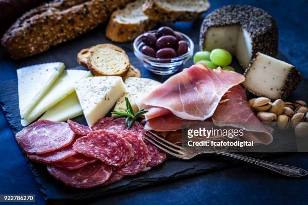 delicious appetizer on bluish tint table - salami stock pictures, royalty-free photos & images