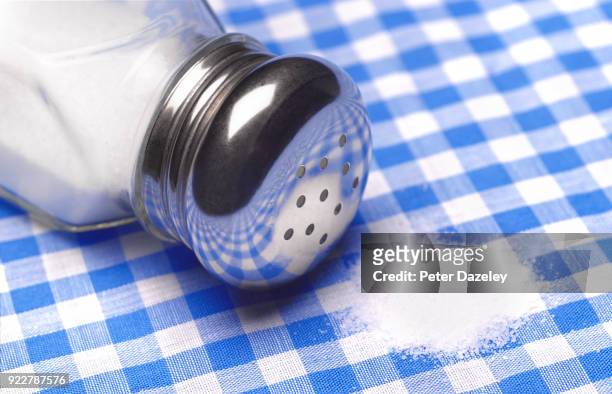 spilt salt from a salt shaker - pfefferstreuer stock-fotos und bilder