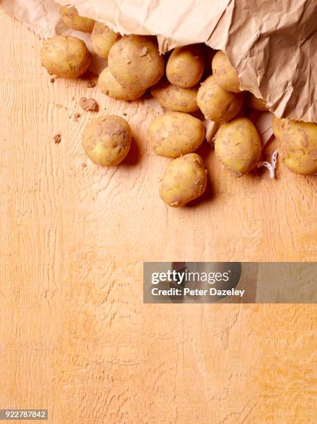 organic new potatoes on wooden board - raw new potato stock pictures, royalty-free photos & images