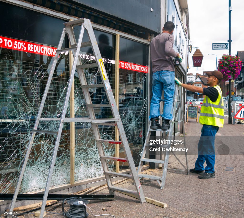 Window Men Two Men Repairing A Vandalised Window High-Res Stock Photo - Getty Images