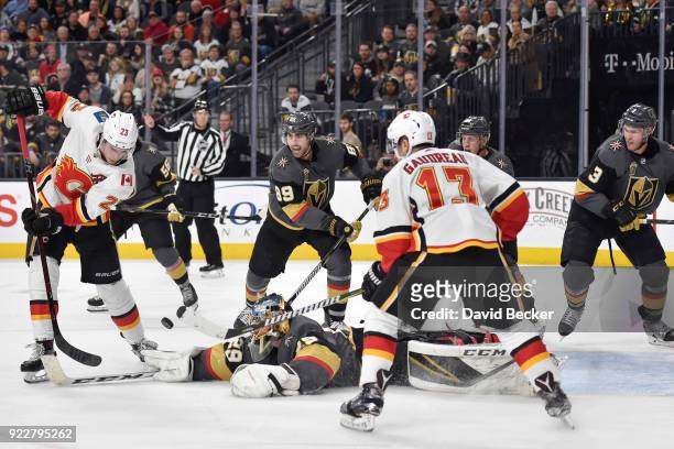 Alex Tuch, Nate Schmidt and Brayden McNabb defend as their teammate goalie Marc-Andre Fleury of the Vegas Golden Knights makes a save against Sean...