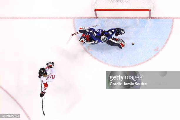 Madeline Rooney of the United States makes a save against Meghan Agosta of Canada in a shootout during the Women's Gold Medal Game on day thirteen of...