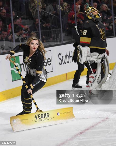 Member of the Knights Crew cleans the ice as Marc-Andre Fleury of the Vegas Golden Knights stands behind the net during the Golden Knights' game...