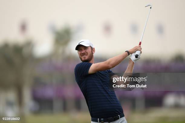 Chris Wood of England hits an approach shot on the 1st hole during the first round of the Commercial Bank Qatar Masters at Doha Golf Club on February...