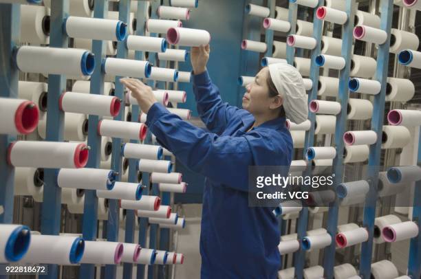 Textile worker works at a factory on February 22, 2018 in Nantong, Jiangsu Province of China. It is the first working day after a week-long spring...