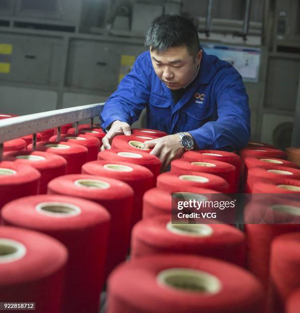 Textile worker checks quality of textile at a factory on February 22, 2018 in Nantong, Jiangsu Province of China. It is the first working day after a...