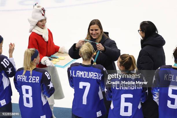 Member Angela Ruggiero contragulates team United States during the victory ceremony for the United States and Canada after the Women's Gold Medal...