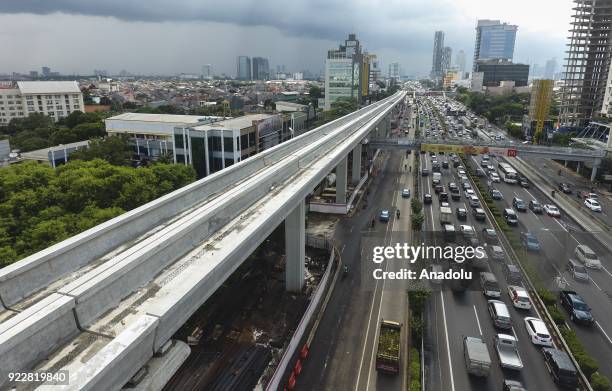 Stream of vehicles pass by the Light Rail Transit construction site in Halim Perdana Kusuma area, Jakarta, Indonesia on February 21, 2018. Jakarta...