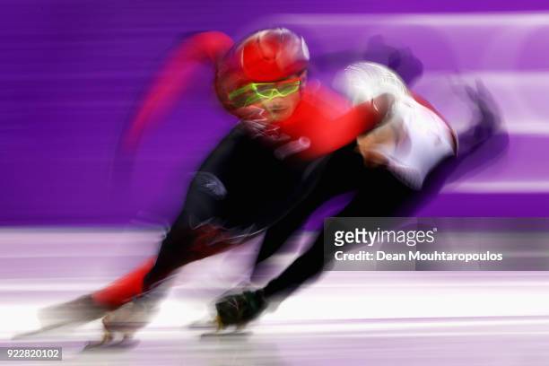 Samuel Girard of Canada and Roberts Zvejnieks of Latvia compete during the Men's Short Track Speed Skating 500m Heats on day eleven of the...