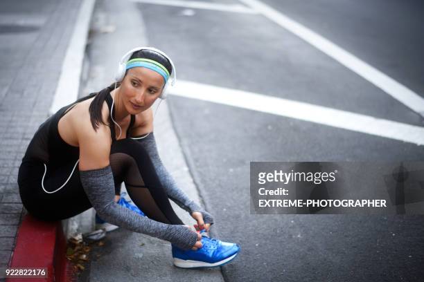sportswoman in the city - untied shoelace stock pictures, royalty-free photos & images