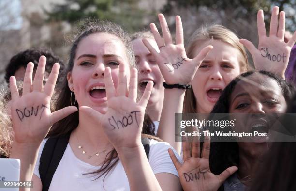 Andrea Bisk, left, a junior at Albert Einstein High School, joins a student rally in front of the U.S. Capitol in Washington, DC on February 21,...