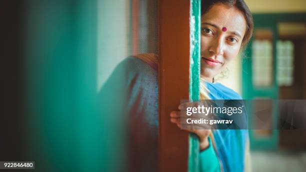young woman looking at camera. - peeking stock pictures, royalty-free photos & images