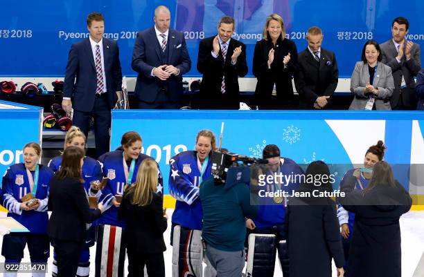 Head coach of USA Robb Stauber and his staff applaud while celebrating the goal medal following the Women's Ice Hockey Gold Medal game final between...