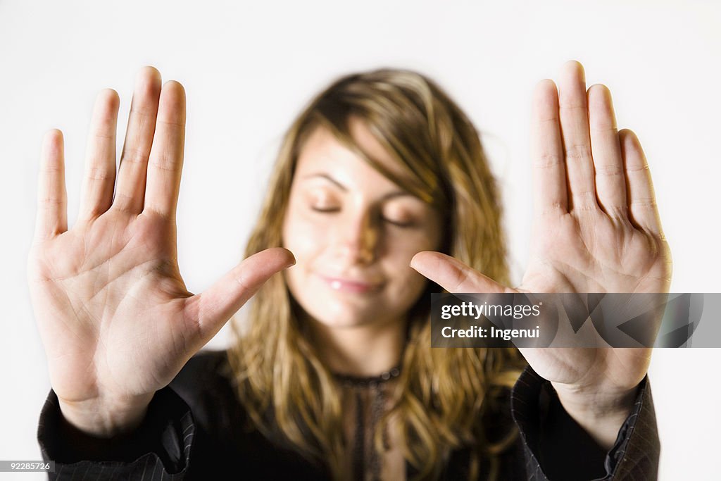 Close-up of woman putting palms up implying no more