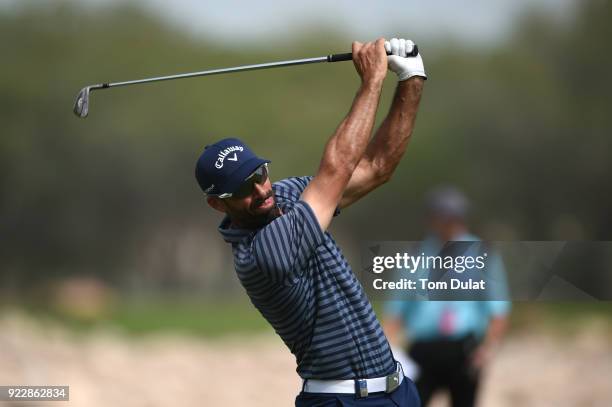 Alvaro Quiros of Spain hits an approach shot on the 18th hole during the first round of the Commercial Bank Qatar Masters at Doha Golf Club on...