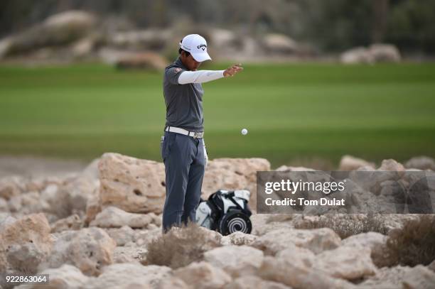 Phachara Thakhongwatmai of Thailand takes a drop on the 18th hole during the first round of the Commercial Bank Qatar Masters at Doha Golf Club on...