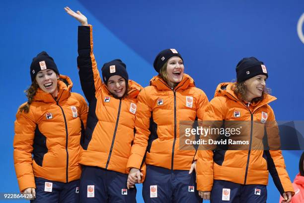 Silver medalists Marrit Leenstra, Lotte Van Beek, Ireen Wust and Antoinette De Jong of the Netherlands celebrate during the medal ceremony for Speed...