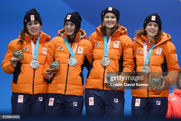 Silver medalists Marrit Leenstra, Lotte Van Beek, Ireen Wust and Antoinette De Jong of the Netherlands celebrate during the medal ceremony for Speed...