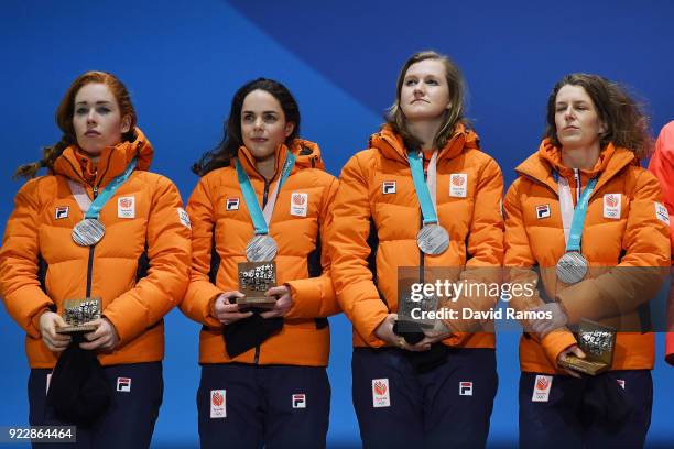 Silver medalists Marrit Leenstra, Lotte Van Beek, Ireen Wust and Antoinette De Jong of the Netherlands stand on the podium during the medal ceremony...