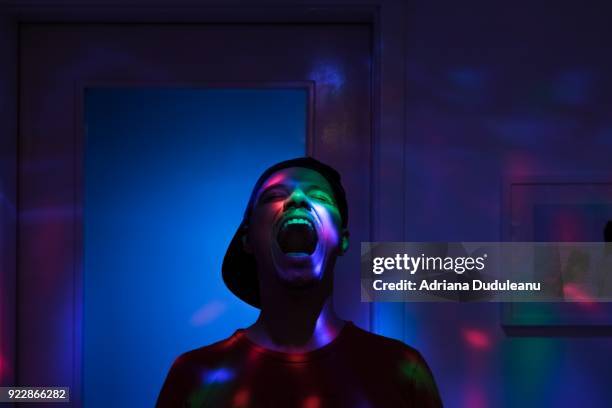 Man Shouting While Standing In Illuminated Room