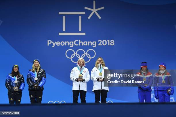 Silver medalists Charlotte Kalla and Stina Nilsson of Sweden, gold medalists Jessica Diggins and Kikkan Randall of the United States and bronze...