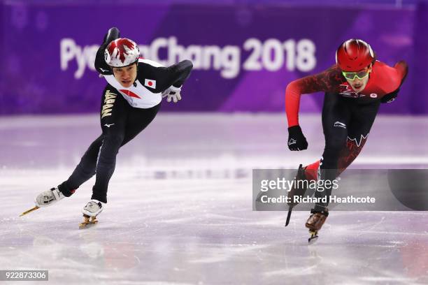 Samuel Girard of Canada and Ryosuke Sakazume of Japan skate during their Men's 500m Short Track Speed Skating Quarter Final on day thirteen of the...