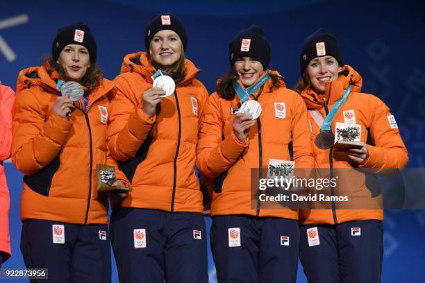 Silver medalists Marrit Leenstra, Lotte Van Beek, Ireen Wust and Antoinette De Jong of the Netherlands stand on the podium during the medal ceremony...