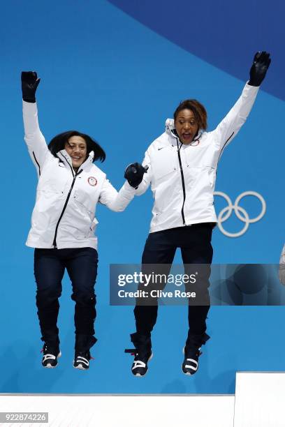 Silver medalists Elana Meyers Taylor and Lauren Gibbs of the United States celebrate during the medal ceremony for Bobsleigh - Women on day 13 of the...