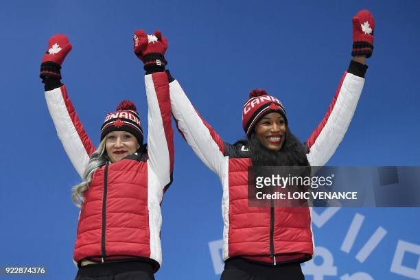 Canada's bronze medallists Kaillie Humphries and Phylicia George pose on the podium during the medal ceremony for the women's bobsleigh at the...