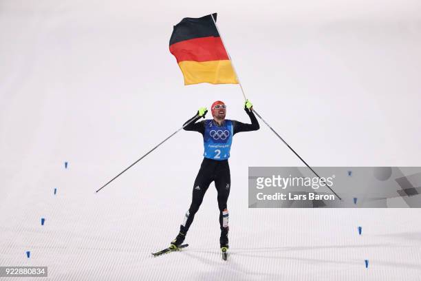 Johannes Rydzek of Germany celebrates winning gold during the Nordic Combined Team Gundersen LH/4x5km, Cross-Country on day thirteen of the...