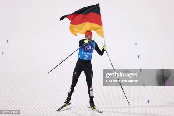 Johannes Rydzek of Germany celebrates winning gold during the Nordic Combined Team Gundersen LH/4x5km, Cross-Country on day thirteen of the...