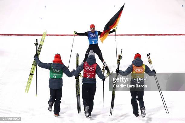 Johannes Rydzek of Germany celebrates winning gold with team mates Vinzenz Geiger of Germany, Fabian Riessle of Germany and Eric Frenzel of Germany...